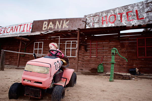 Broken down lawn mower/ possible tractor in front of makeshift town